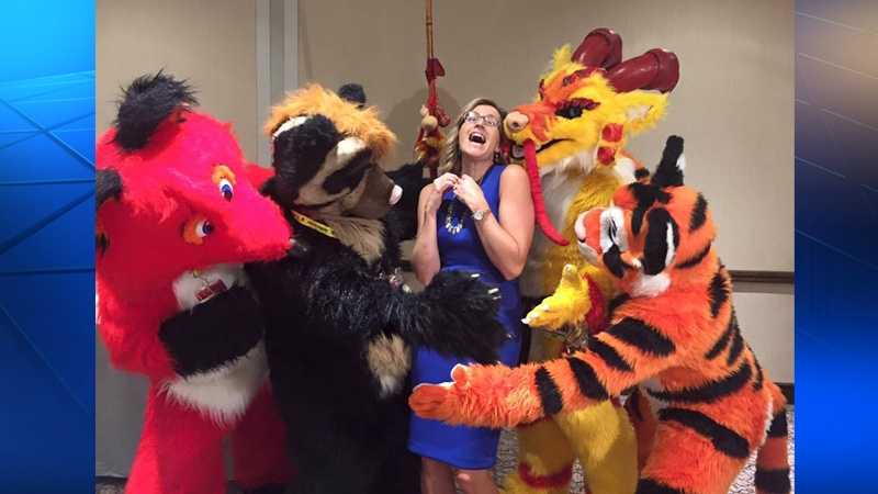 Shannon Perrine is surrounded by furries.