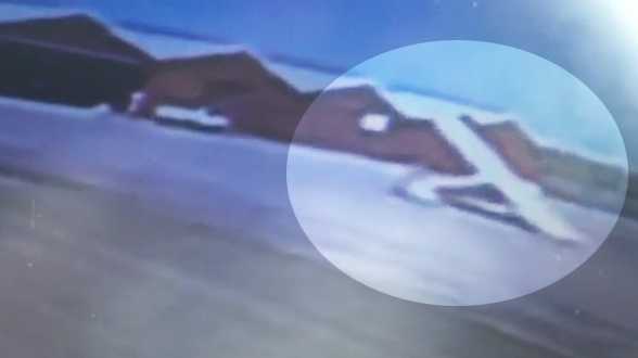 This image from surveillance video shows the plane as it spins out of control.