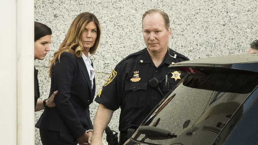 Former Pennsylvania Attorney General Kathleen Kane is escorted from Montgomery County courthouse after her sentencing hearing in Norristown, Pa, Monday, Oct. 24, 2016.