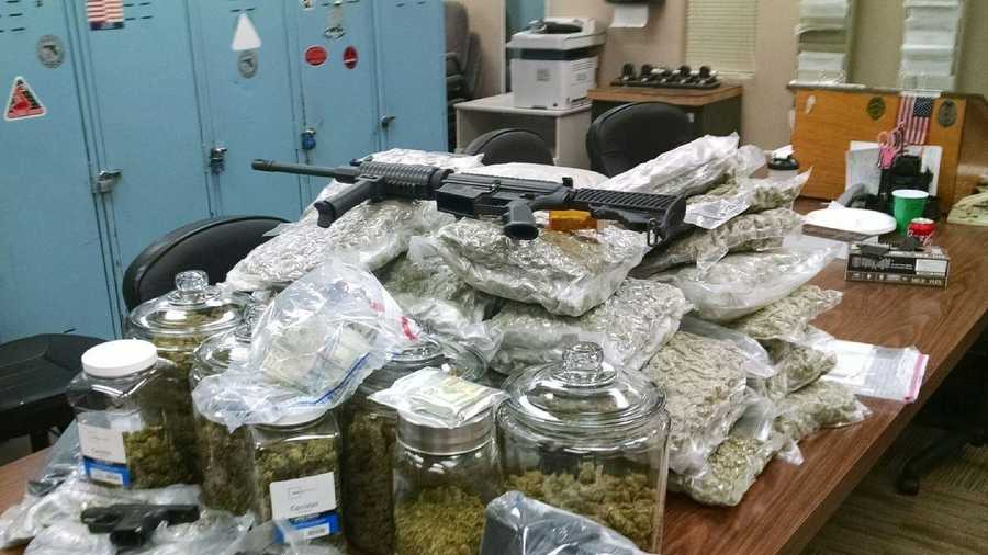 Officers found nearly 90 pounds of marijuana, an assault rifle and $15,000 in cash.