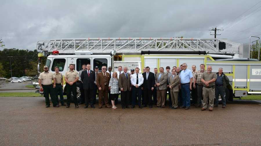 AFC associates and members of the Sumiton VFD stand with the new truck, along with Assistant State Forester Dan Jackson, Walker County Commission Chairman Billy Luster, Walker County EMA Coordinator Regina Myers, State Senator Greg Reed, Sumiton VFD Chief David Waid, State Representative Tim Wadsworth, State Forester Greg Pate, U.S. Congressman Robert B. Aderholt's District Field Director Paul Housel, and Walker County Fire Association President Terry McCullar.