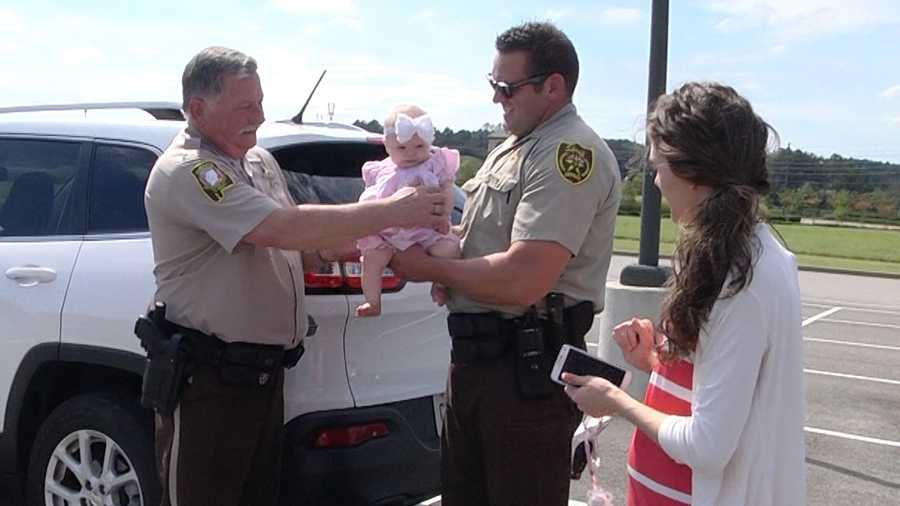 Deputies Ric Lindley and Tim Sanford reunite with Monica Johnson and her daughter, Aubrie Ella. A photo of Aubrie Ella and Lindley at a wreck scene Tuesday went viral