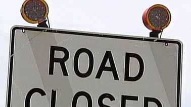 sign that says "road closed"