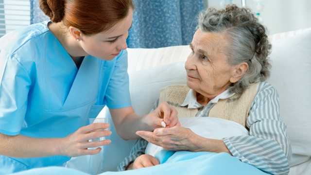 Nurse with senior woman, nursing home
