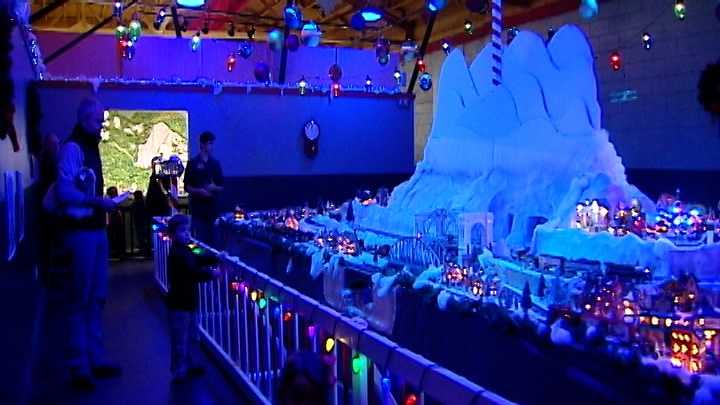The Christmas-theme exhibit at the Miniature World of Trains features four model trains trekking through a snow-covered mountain town.