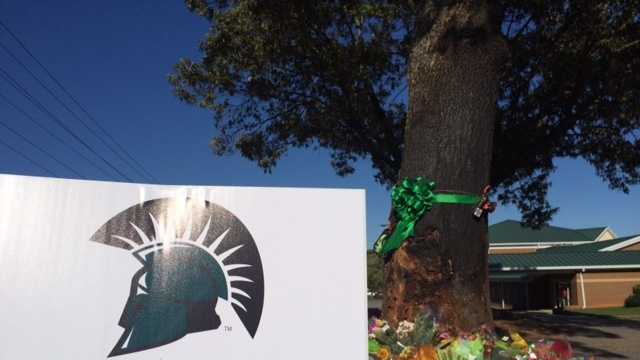 A color memorial marks the site where a crash killed four USC Upstate students and injured a fifth.