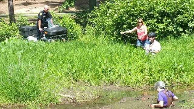 A woman and her dog had to be rescued by Furman University police Wednesday after they got stuck in the mud.