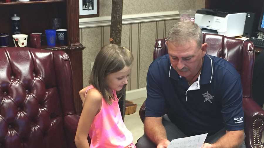 Spartanburg County Sheriff Chuck Wright meets 6-year-old Kinslee Parris, who wrote a heartfelt letter to officers.