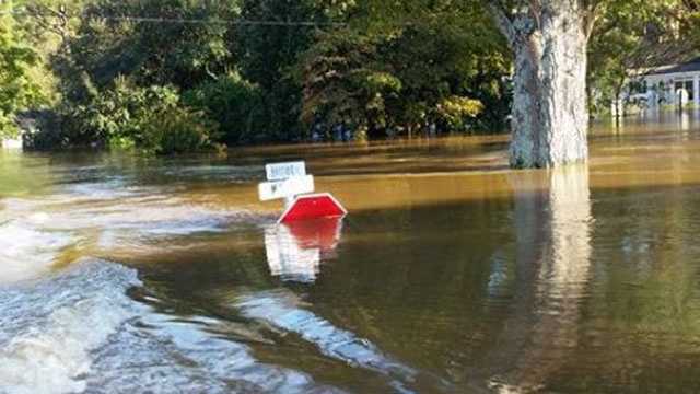 A stop sign is almost completely underwater at an intersection in Seven Springs, North Carolina, near the Neuse River.