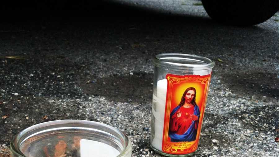 Blood and memorial candles are seen on Parkside Drive where Ruben Francisco, 23, was killed by two gunmen Aug. 4.