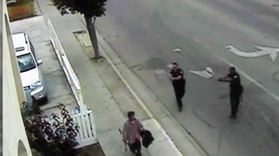 Carlos Mejia, left, is seen seconds before two officers, right, shot and killed him on May 20, 2014. 