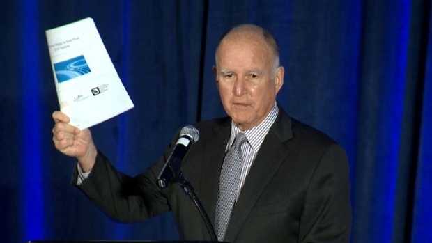 Gov. Jerry Brown holds a copy of the California Water Action Plan 2016 update.