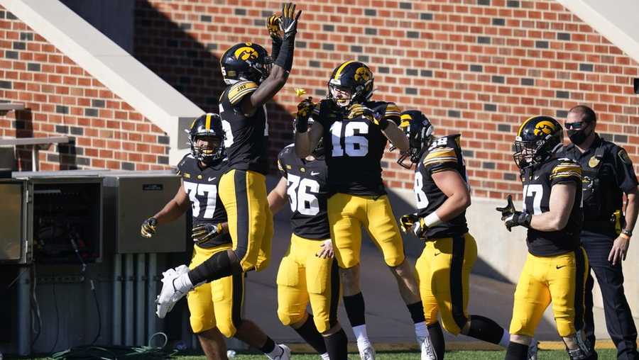Iowa's Charlie Jones (16) celebrates with teammates after returning a punt 54-yards for a touchdown during the first half of an NCAA college football game against Michigan State, Saturday, Nov. 7, 2020, in Iowa City, Iowa. (AP Photo/Charlie Neibergall)
