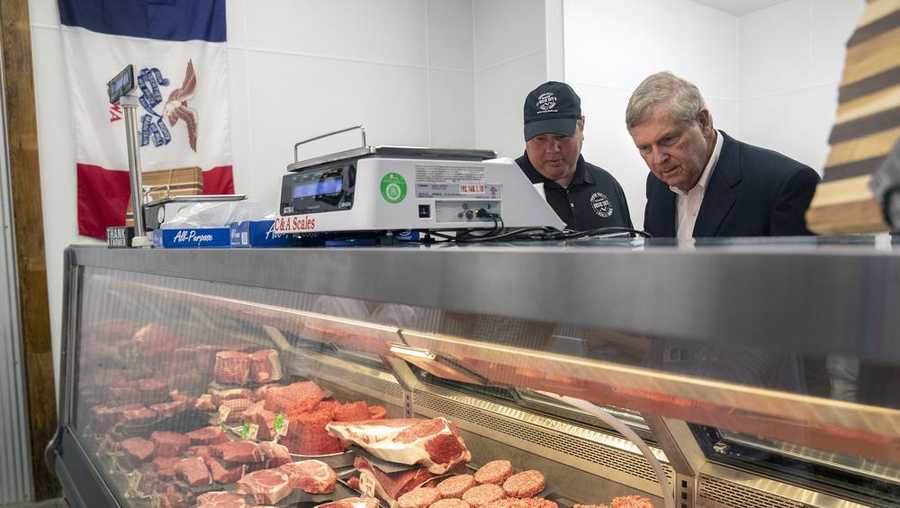 u.s. secretary of agriculture tom vilsack, right, checks out the meat counter at rustic cuts with co-owner jake driver, left, on friday, july 9, 2021 in council bluffs, iowa. u.s. agriculture secretary tom vilsack announces his plan to spend $500 million to encourage the construction of smaller meat processing plants located closer to farmers who raise chickens, pigs and cows with the goal of diversifying an industry now consolidated among a few large processors. (joe shearer/the daily nonpareil via ap)