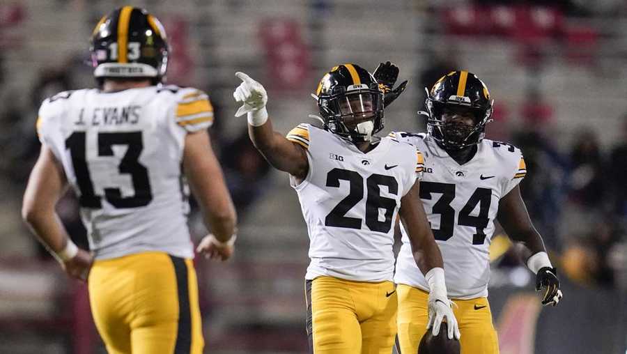file - iowa defensive back kaevon merriweather (26) reacts after making an interception on a pass from maryland quarterback taulia tagovailoa, not visible, during the second half of an ncaa college football game in college park, md., in this friday, oct. 1, 2021, file photo. iowa defensive end joe evans (13) and linebacker jay higgins (34) look on. the key matchup in fourth-ranked penn state's showdown with no. 3 iowa pits the nittany lions' passing combo of sean clifford and jahan dotson against a defense that leads the nation with 12 interceptions. (ap photo/julio cortez, file)