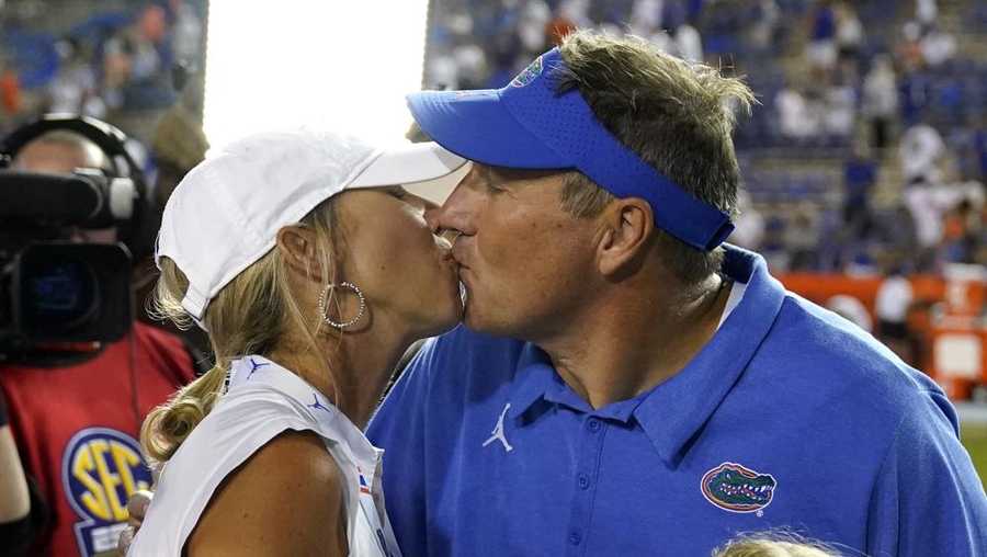 Florida coach Dan Mullen, right, gets a kiss from his wife, Megan, after Florida defeated Florida Atlantic in an NCAA college football game Saturday, Sept. 4, 2021, in Gainesville, Fla. (AP Photo/John Raoux)