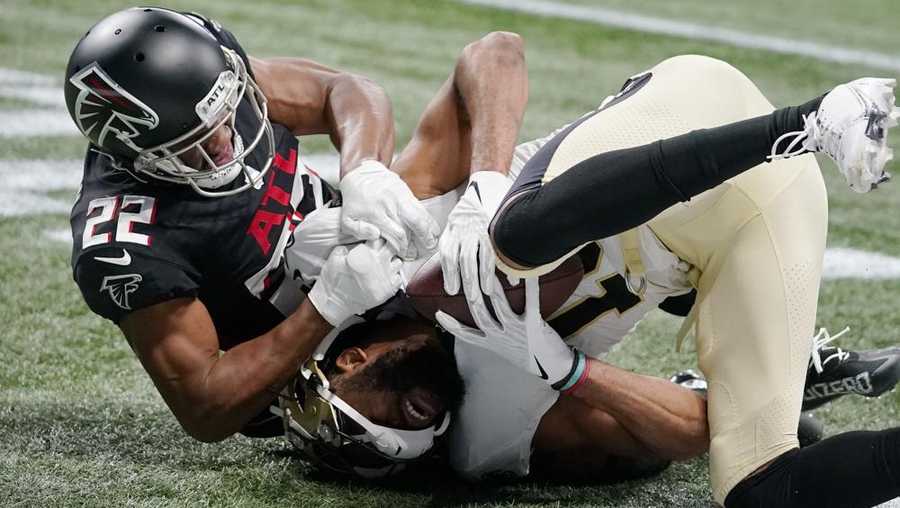 atlanta falcons cornerback fabian moreau (22) late hits new orleans saints wide receiver tre'quan smith (10) after smith scored a touchdown during the first half of an nfl football game, sunday, jan. 9, 2022, in atlanta. moreau drew a foul on the play. (ap photo/brynn anderson)