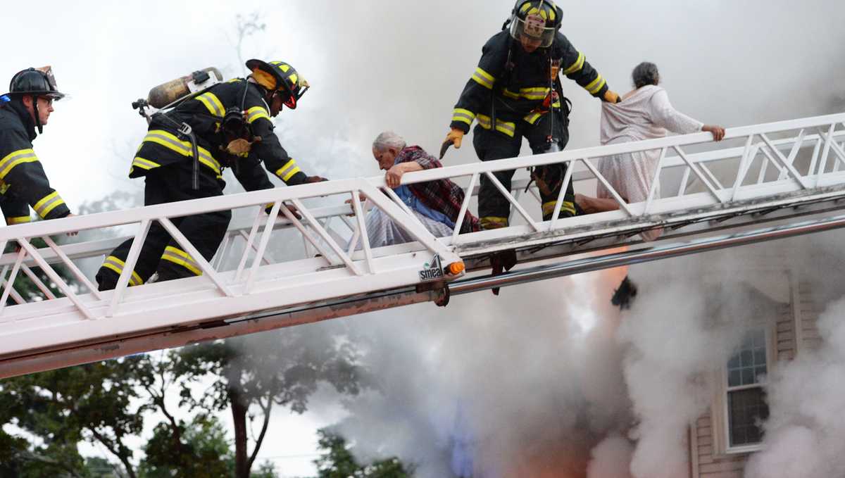 Images: Family rescued by ladder from raging fire