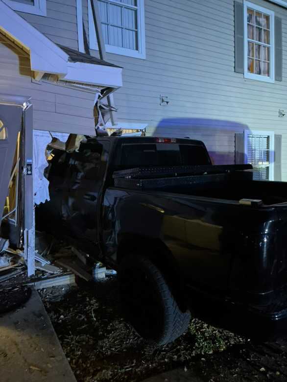 The black Ford pickup after it made contact with the apartment Sunday around 8:30pm. ﻿