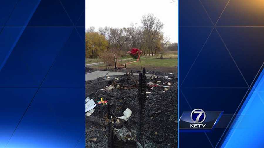 Family return to the site of the deadly house fire, leaving behind a rose