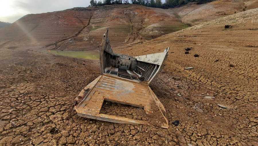 a boat from the uss monrovia emerged from the shores of lake shasta as the california drought continued in october.