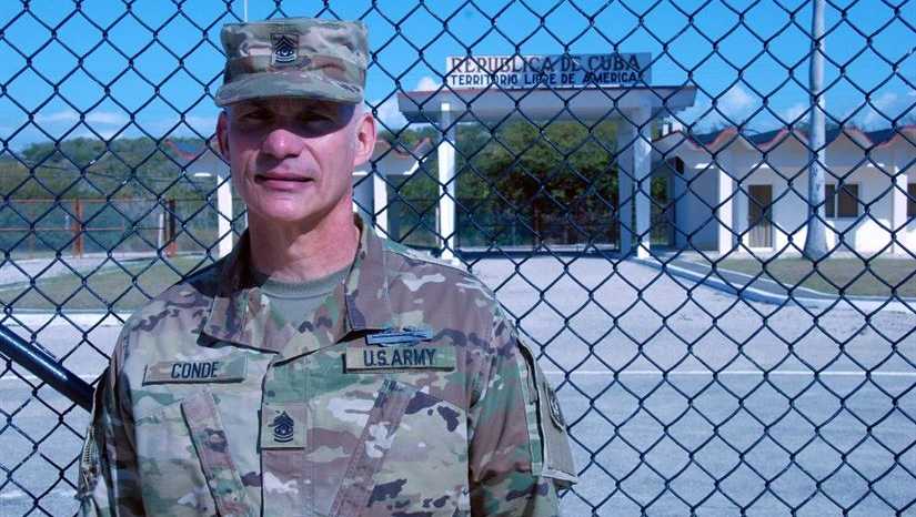 Command Sgt. Maj. Rafael Conde, the Wisconsin Army National Guard’s senior enlisted leader, stands by the northeast gate at Naval Station Guantanamo Bay, Cuba, Dec. 30, 2016. Conde was born in Cuba and fled to the United States as a child with his family. He returned to Cuba as part of an official visit led by Wisconsin Gov. Scott Walker and Maj. Gen. Don Dunbar, Wisconsin’s adjutant general, to visit with members of the Wisconsin Army National Guard’s 32nd Military Police Company deployed to Guantanamo Bay. 