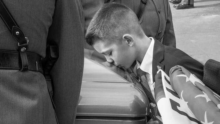 Brian Falb Jr. kisses his father's casket