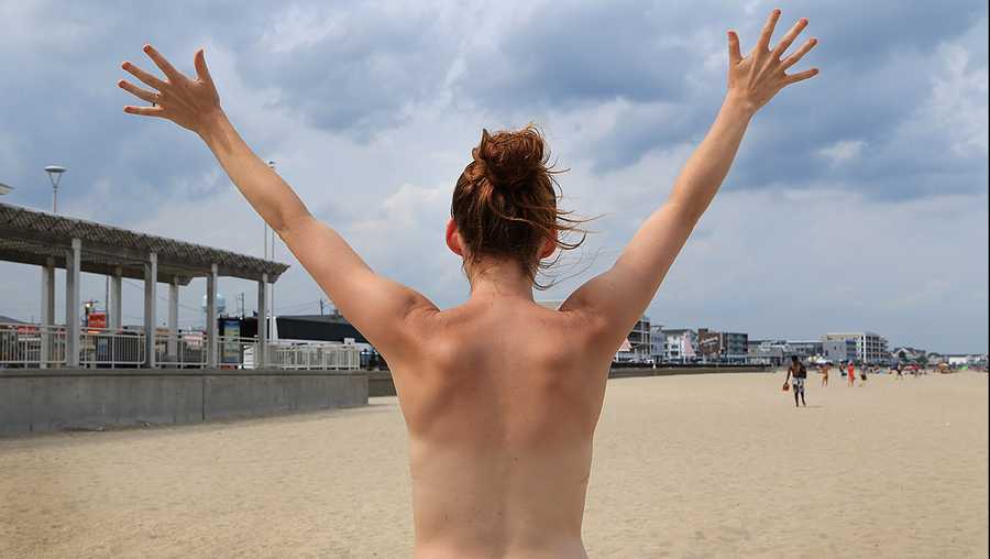 Kia Sinclair stands topless on Hampton Beach in Hampton, N.H., on July 30, 2015. She is one of three New Hampshire women asking the Supreme Court to declare that a city ordinance banning women from appearing topless in public violates the Constitution.
