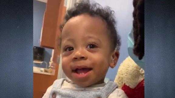 A toddler is fitted with hearing aids and hears his mom's voice for the first time.