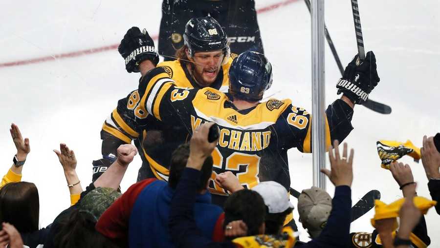 Boston Bruins&apos; Brad Marchand (63) celebrates his goal with David Pastrnak during the second period of Game 3 of an NHL hockey Stanley Cup first-round playoff series against the Carolina Hurricanes, Friday, May 6, 2022, in Boston. (AP Photo/Michael Dwyer)