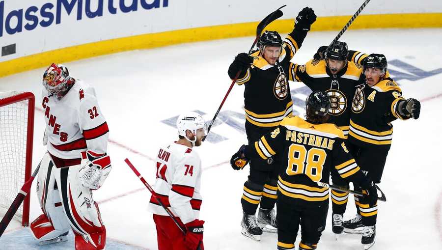 Boston Bruins&apos; Charlie Coyle (13) celebrates with teammates after scoring on Carolina Hurricanes goalie Antti Raanta (32) during the second period in Game 6 of an NHL hockey Stanley Cup first-round playoff series Thursday, May 12, 2022, in Boston. (AP Photo/Michael Dwyer)