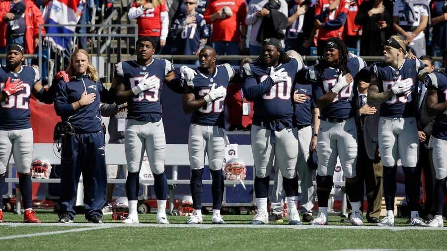 New England Patriots stand during national anthem before Panthers game