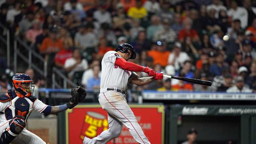 Boston Red Sox&apos;s Rafael Devers, right, hits a home run as Houston Astros catcher Martin Maldonado reaches for the pitch during the sixth inning of a baseball game Tuesday, Aug. 2, 2022, in Houston. (AP Photo/David J. Phillip)