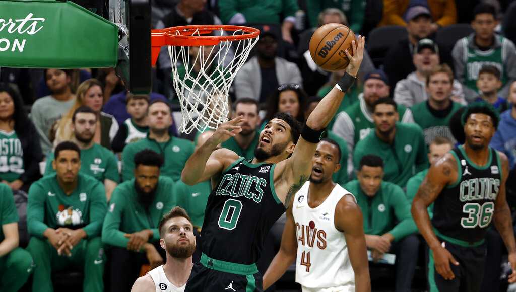 Boston Celtics' Jaylen Brown dunks over Cleveland Cavaliers