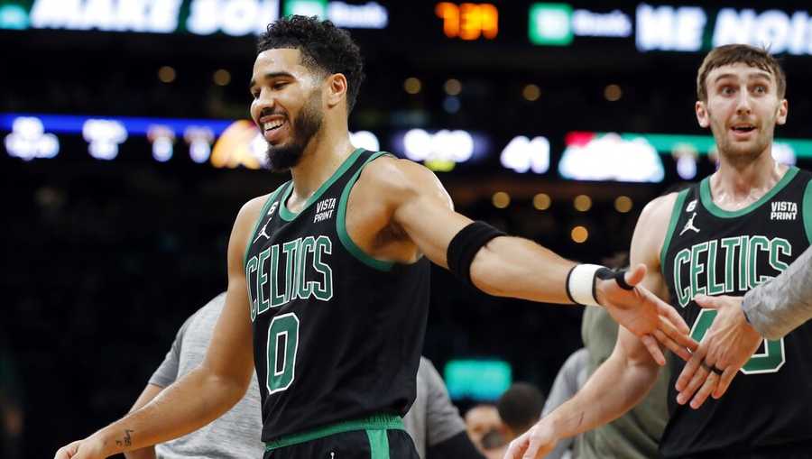 Boston Celtics&apos; Jayson Tatum (0) reacts after making a three-pointer during the first half of an NBA basketball game against the Denver Nuggets, Friday, Nov. 11, 2022, in Boston. (AP Photo/Michael Dwyer)