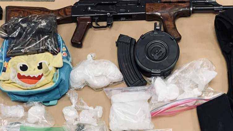 gun, drugs and ammo on a table.