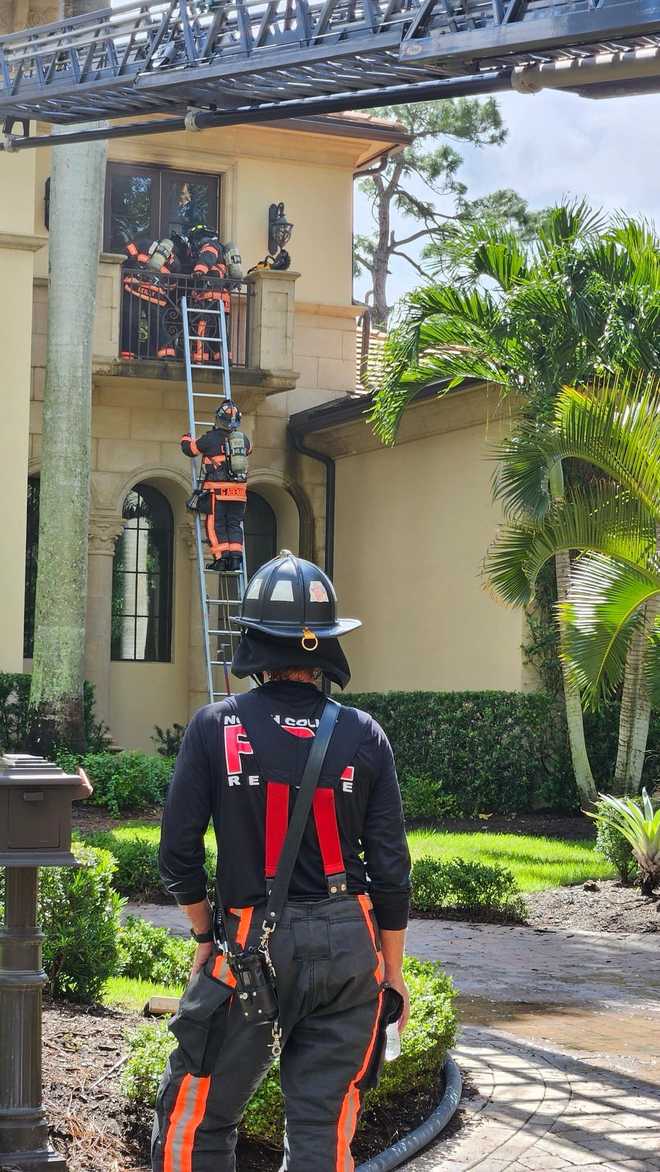 ﻿North Collier Fire and Rescue District Firefighters work to put out flames. ﻿