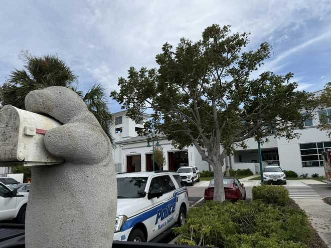 ﻿Milton the ﻿Mailbox Manatee paying his outstanding parking tickets at the Marco Island Police Department HQ.