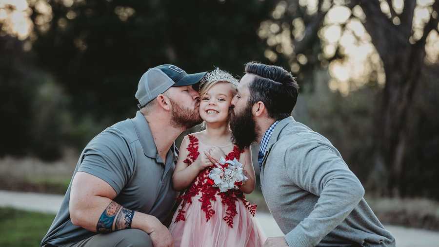 Soon-to-be stepdad Dylan Lenox and dad David Lewis give Willow a kiss on each cheek.
