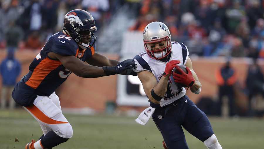 New England Patriots wide receiver Julian Edelman, right, is pushed out by Denver Broncos inside linebacker Corey Nelson during the first half of an NFL football game Sunday, Dec. 18, 2016, in Denver. 