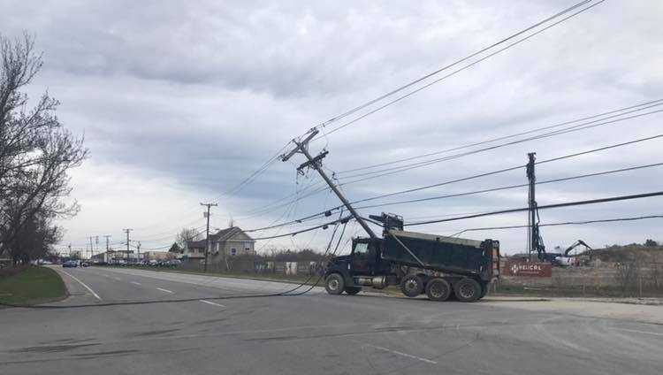 Dump truck takes down wires, closing stretch of busy Westbrook road