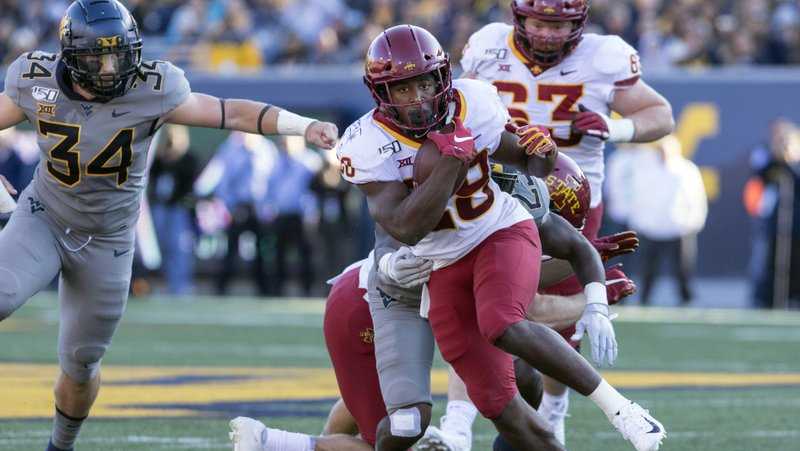 Iowa State running back Breece Hall (28) escape the tackle of West Virginia safety Tykee Smith (23) during the first half of an NCAA college football game Saturday, Oct. 12, 2019, in Morgantown, W.Va. (AP Photo/Raymond Thompson)