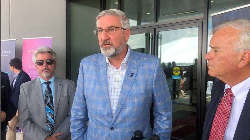 Indiana Gov. Eric Holcomb speaks with reporters following a grand opening ceremony at an Abbott medical device production facility in Westfield, Indiana, on Thursday, July 1, 2021. Holcomb said the state needed "to grind this out" as it works to improve Indiana's lagging COVID-19 vaccination rate. (