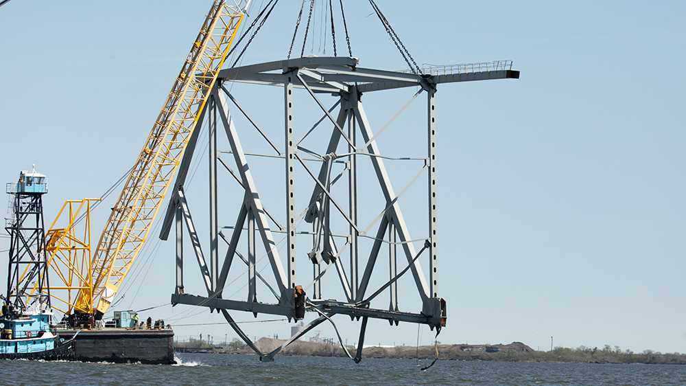 Floating barge removes large pieces of Key Bridge