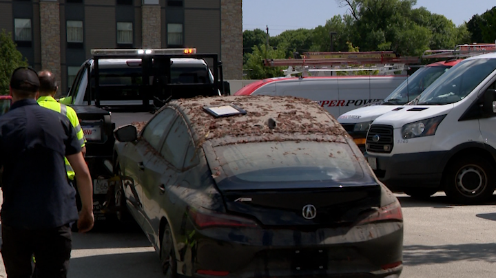 Tow trucks pull totaled, muck-covered cars from flooded West Allis garage