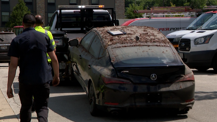 Tow trucks pull totaled, muck-covered cars from flooded West Allis garage