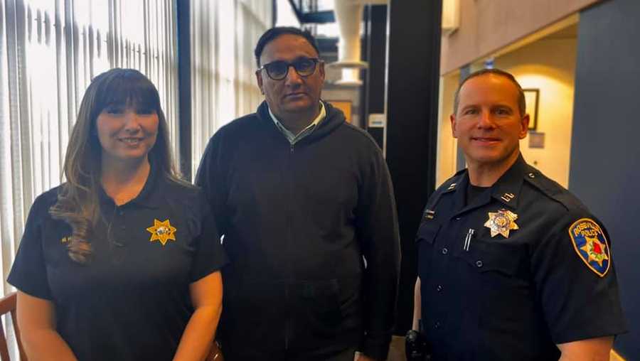 Rajbir Singh saved an elderly passenger in his cab from giving a scammer $25,000 in Roseville, California. He is flanked by Roseville Police records clerk Megan Harrigan and police Capt. Josh Simon.
