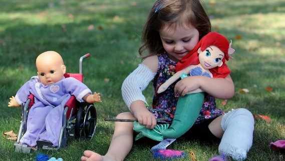Abigail Reardon playing with dolls