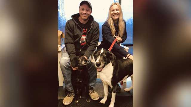 This undated photo provided by Shelly Broniec in December 2018 shows Eric and Tiffany Dybas with dogs Sam and Cosmo at the shelter of PAWS Tinley Park in suburban Chicago. The two dogs escaped death when a northwestern Indiana veterinarian refused the previous owner's request to have the healthy canines euthanized.
