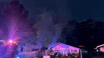 Firefighters battle house fire on in the bitter cold